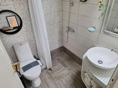 a bathroom with a toilet and a sink at Modern Quiet Apartment in the Center of Rhodes in Rhodes Town