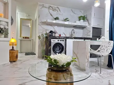 a living room with a glass table and a microwave at Modern Quiet Apartment in the Center of Rhodes in Rhodes Town