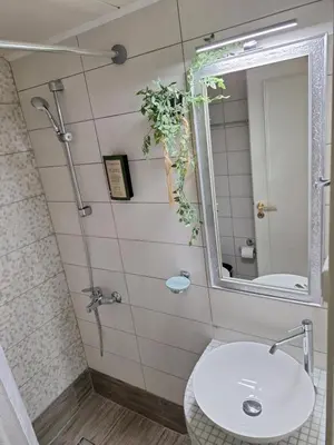 a bathroom with a sink and a mirror at Modern Quiet Apartment in the Center of Rhodes in Rhodes Town
