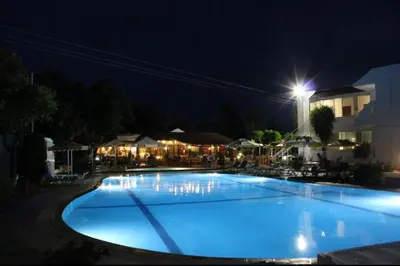 a large blue swimming pool at night at Asterias Bay-Theologos in Theologos