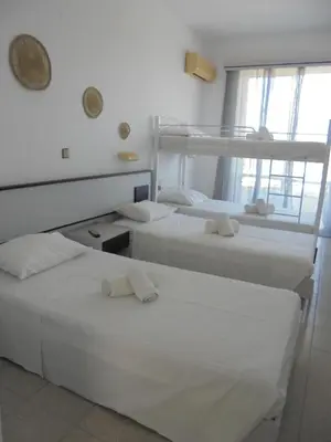 a bedroom with two bunk beds and a window at Asterias Bay-Theologos in Theologos