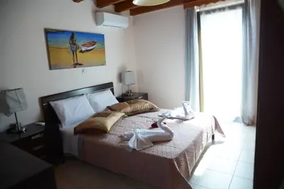 a bedroom with a bed with towels on it at Mary's dreams Villa in Symi