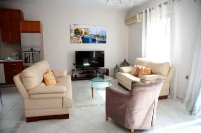 a living room with two chairs and a tv at Mary's dreams Villa in Symi