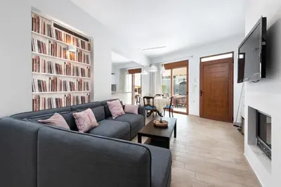 a living room with a couch and a tv at Ritas Modern In-City House in Rhodes Town