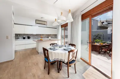 a kitchen and dining room with a table and chairs at Ritas Modern In-City House in Rhodes Town