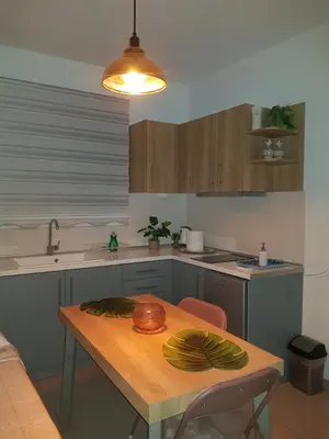 a kitchen with a wooden table with a bowl on it at Galazia Thea Apartments in Archangelos