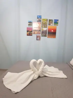 a towel in the shape of a heart on a bed at Galazia Thea Apartments in Archangelos