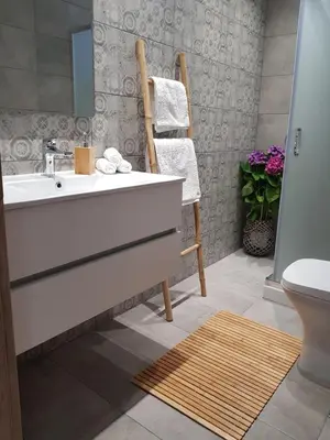 a bathroom with a white sink and a toilet at Galazia Thea Apartments in Archangelos