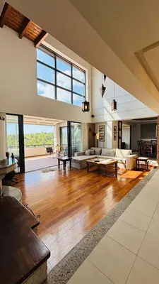 a large living room with wooden floors and a large window at Elena's Country Home & SPA in Kalithies