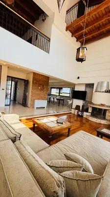 a large living room with a couch and a table at Elena's Country Home & SPA in Kalithies