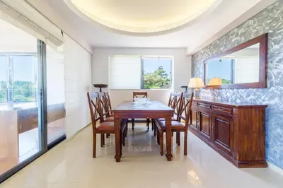 a dining room with a wooden table and chairs at Elena's Country Home & SPA in Kalithies