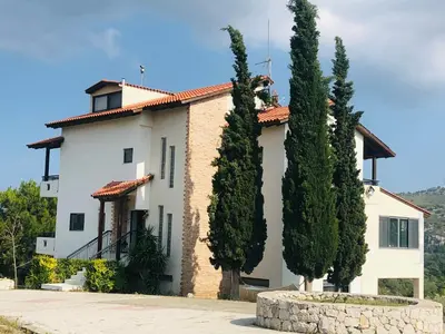 a house with trees in front of it at Elena's Country Home & SPA in Kalithies