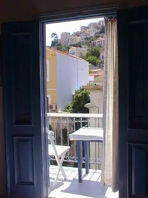 a view of a balcony with a table and a chair at Albatros in Symi
