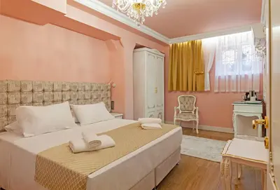 a bedroom with a large bed with two towels on it at Via Villa Iliotti Rhodos in Rhodes Town