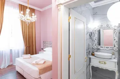 a pink bedroom with a sink and a mirror at Via Villa Iliotti Rhodos in Rhodes Town