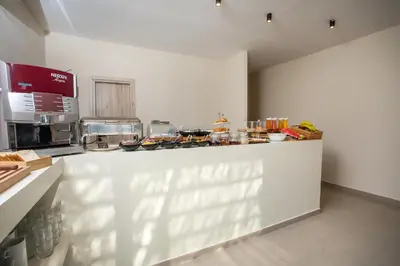 a kitchen with a counter with food on it at Atma Beach Rooms & Suites in Faliraki