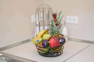 a basket of fruit sitting on a kitchen counter at Golden sunrise stegna in Archangelos