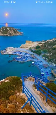 an aerial view of a harbor with boats in the water at Golden sunrise stegna in Archangelos