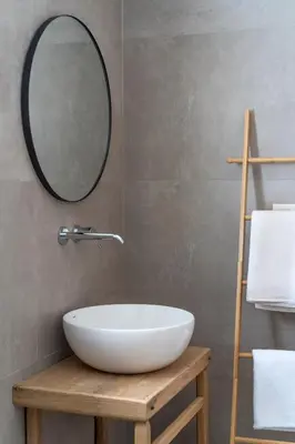 a bathroom with a white sink and a mirror at Terra d'Oro Sea view villa with private pool in Kiotari