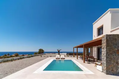 a villa with a swimming pool and a house at Terra d'Oro Sea view villa with private pool in Kiotari