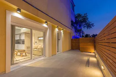 a balcony of a house with a view of a bedroom at Elia & Anthos Deluxe Suites in Ixia