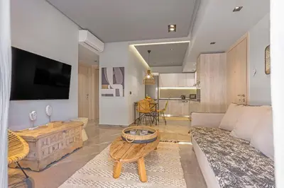 a living room with a couch and a table at Elia & Anthos Deluxe Suites in Ixia