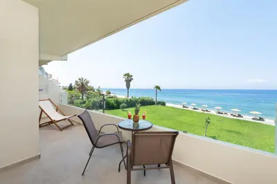 a balcony with a table and chairs and the ocean at Ixia Dream hotel - Adults only in Ixia