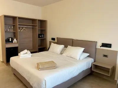 a bedroom with a large bed with white sheets at Ixia Dream hotel - Adults only in Ixia