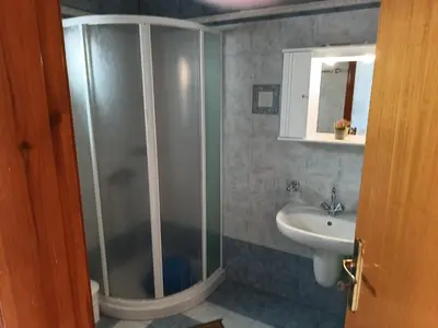 a bathroom with a shower and a sink at Zoe Apartments in Symi