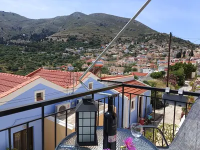 a view of a city from the balcony of a house at Zoe Apartments in Symi