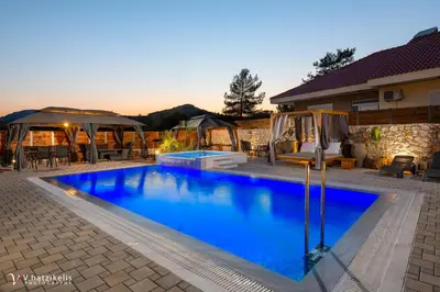 a swimming pool in the backyard of a house at Panthea Luxury Villa in Triánta