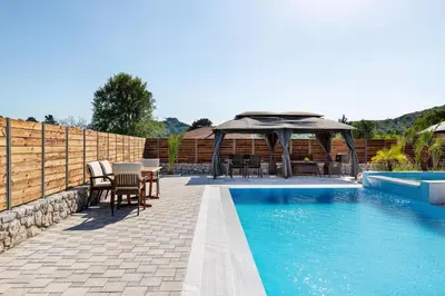 a patio with a gazebo and a swimming pool at Panthea Luxury Villa in Triánta