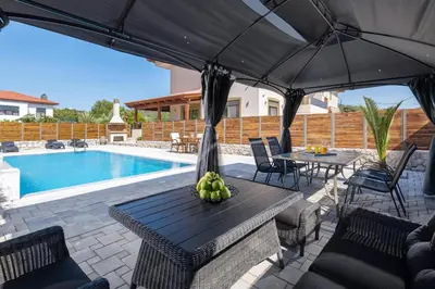 a table with bananas on it next to a pool at Panthea Luxury Villa in Triánta