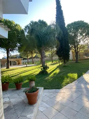 a view of a park with trees and plants at Nostrana Village Apartments in Koskinou