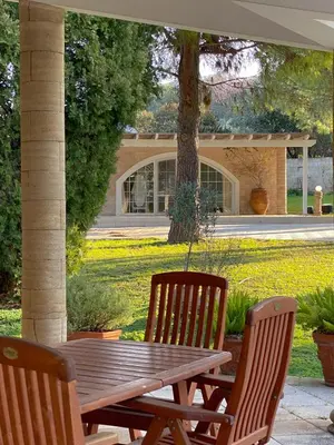 a wooden table and two chairs sitting next to a table at Nostrana Village Apartments in Koskinou