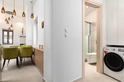 a kitchen and dining room with a washing machine and a dining table at Onirico House in Rhodes Town