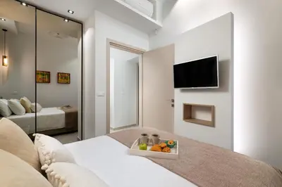 a living room with a bed with a bowl of fruit at Onirico House in Rhodes Town