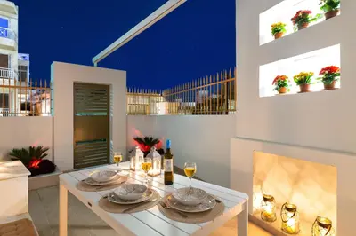 a dining room with a white table with glasses of wine at Onirico House in Rhodes Town