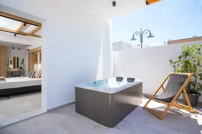 a room with a tub in the middle of a building at Cactus Suites in Faliraki