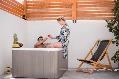 a woman standing in a bath tub with a man at Cactus Suites in Faliraki