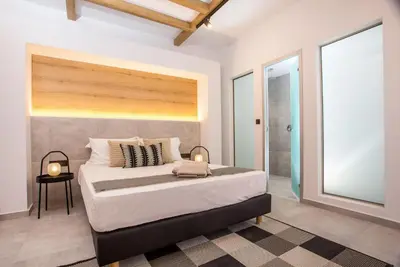 a bedroom with a large bed in a room at Cactus Suites in Faliraki