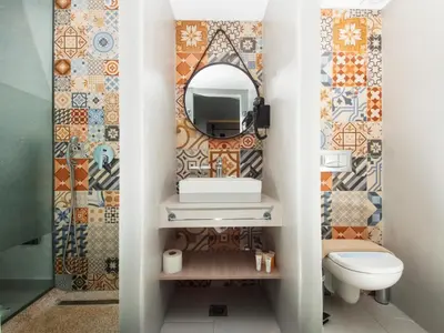 a bathroom with a sink and a mirror at Lymberia Hotel in Faliraki