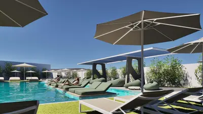 a swimming pool with lounge chairs and umbrellas at Lymberia Hotel in Faliraki