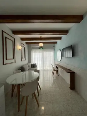 a living room with a white table and a couch at Skizenas Waterfront Apartments in Haraki