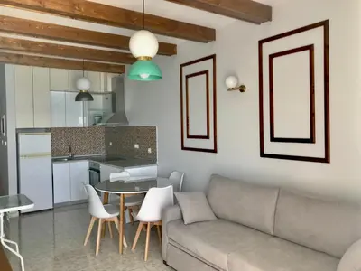 a living room with a couch and a table at Skizenas Waterfront Apartments in Haraki