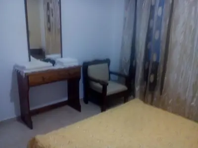 a bedroom with a desk and a chair and a mirror at Nikos and Eva Studios in Symi