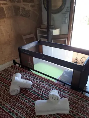 two rolls of toilet paper sitting on a bed at Traditional Stone house in Rhodes Town