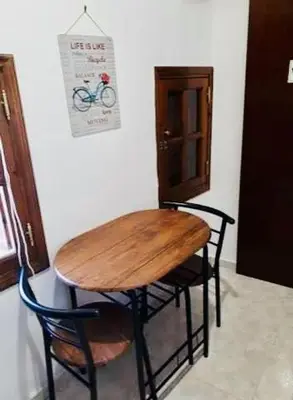 a wooden table and chairs in a room at Traditional Stone house in Rhodes Town