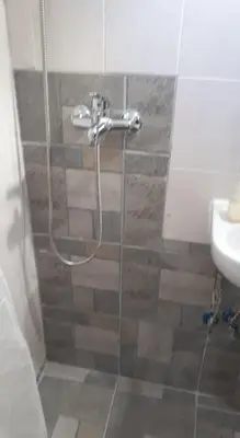 a shower in a bathroom with a sink at Traditional Stone house in Rhodes Town