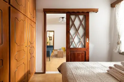 a bedroom with a bed and a wooden door at Sea La Vie Villa Symi in Symi